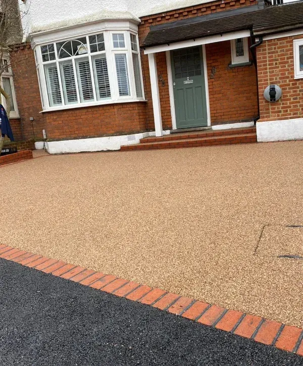Clean residential driveway in front of a brick home with fresh appearance
