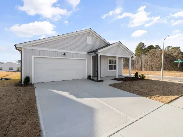 Freshly cleaned driveway in front of a modern home with smooth concrete surface