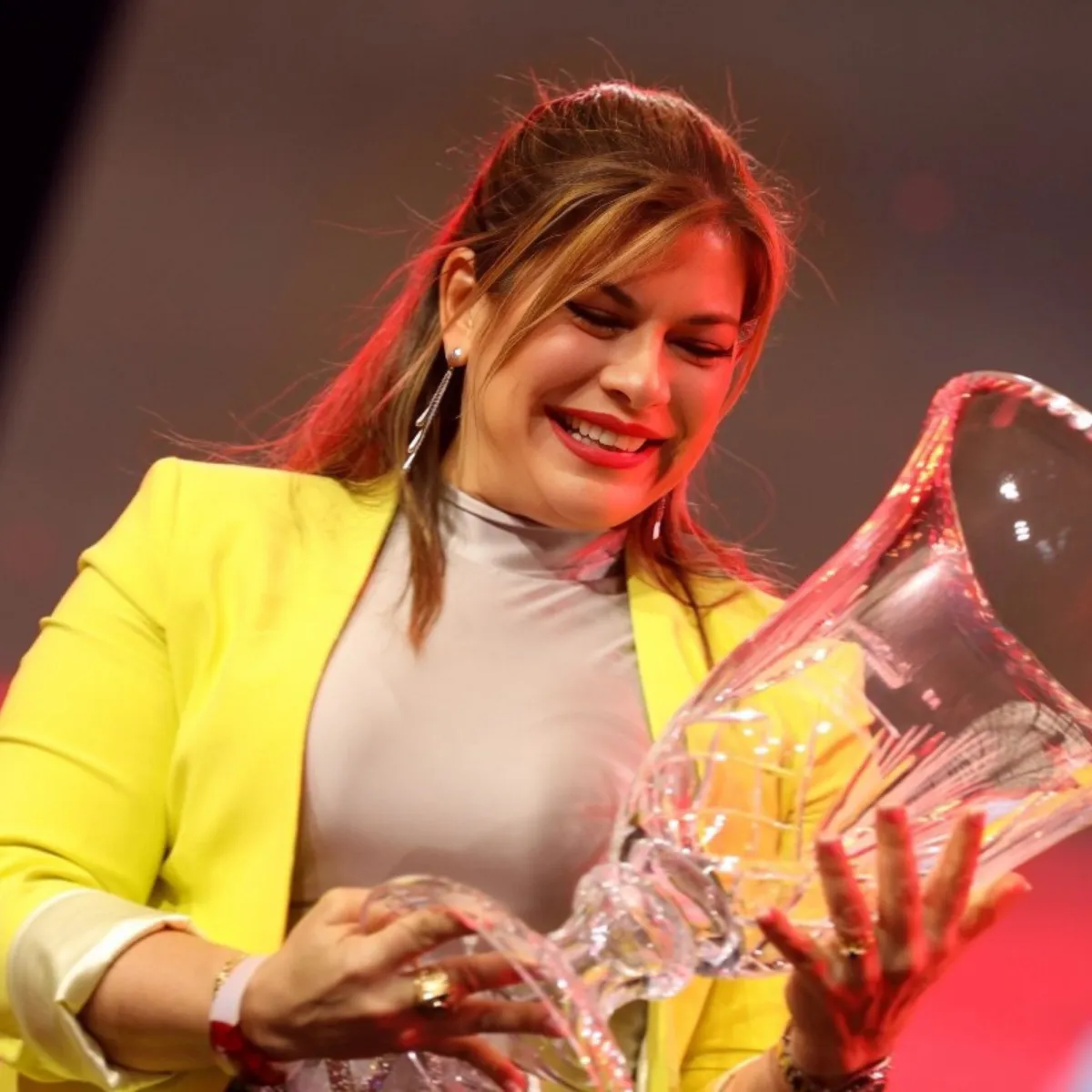 Moibett Rovero recibiendo premio de impacto en evento internacional por su liderazgo y contribución al desarrollo de líderes latinos