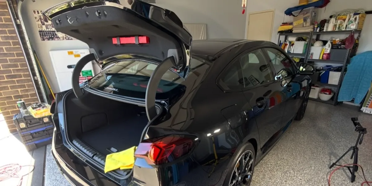 bmw being cleaned with bonnet open