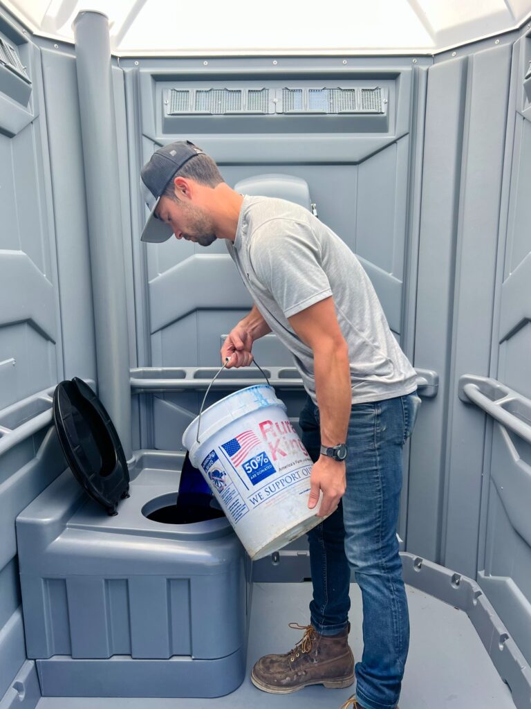 person washing hands in open faucet