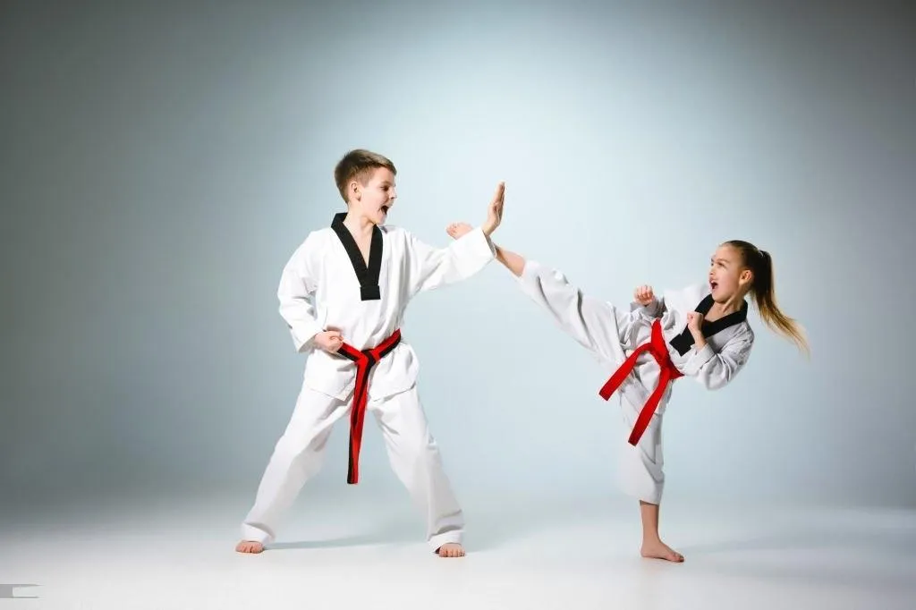 boy blocking girl's high kick 