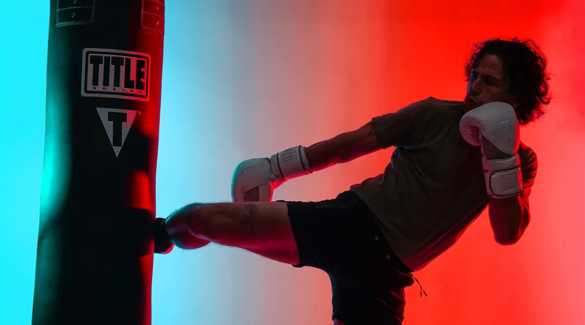 UFC fighter Urijah Faber kicking a heavy bag