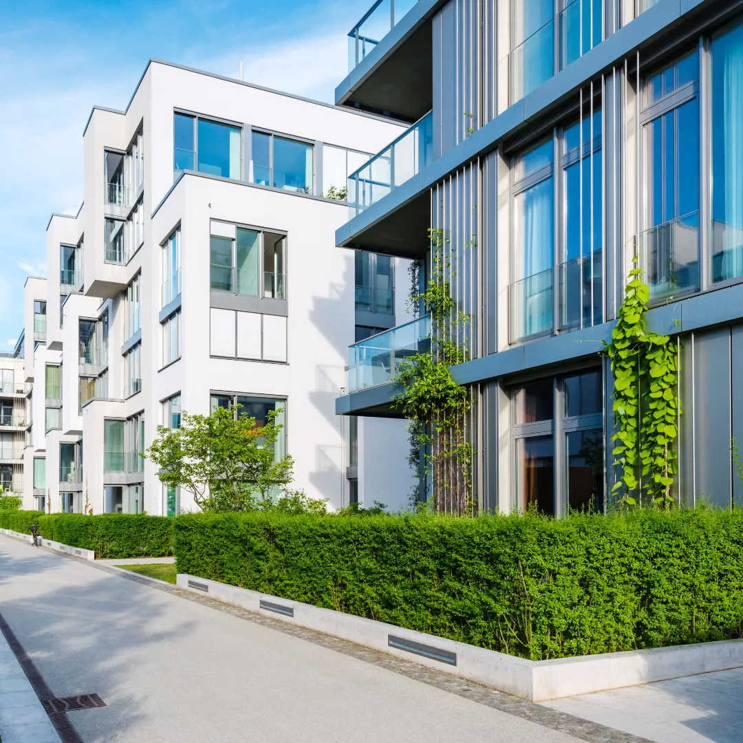 Contemporary multi-storey apartment buildings with glass balconies and landscaped surroundings