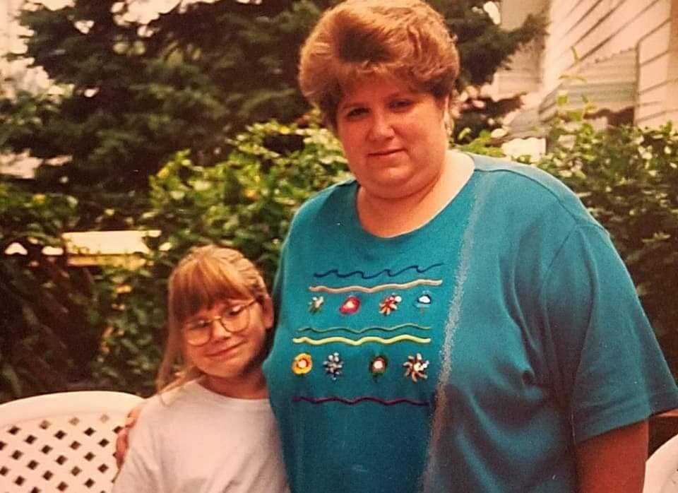 Smiling woman checking a meal-planning app in a bright kitchen