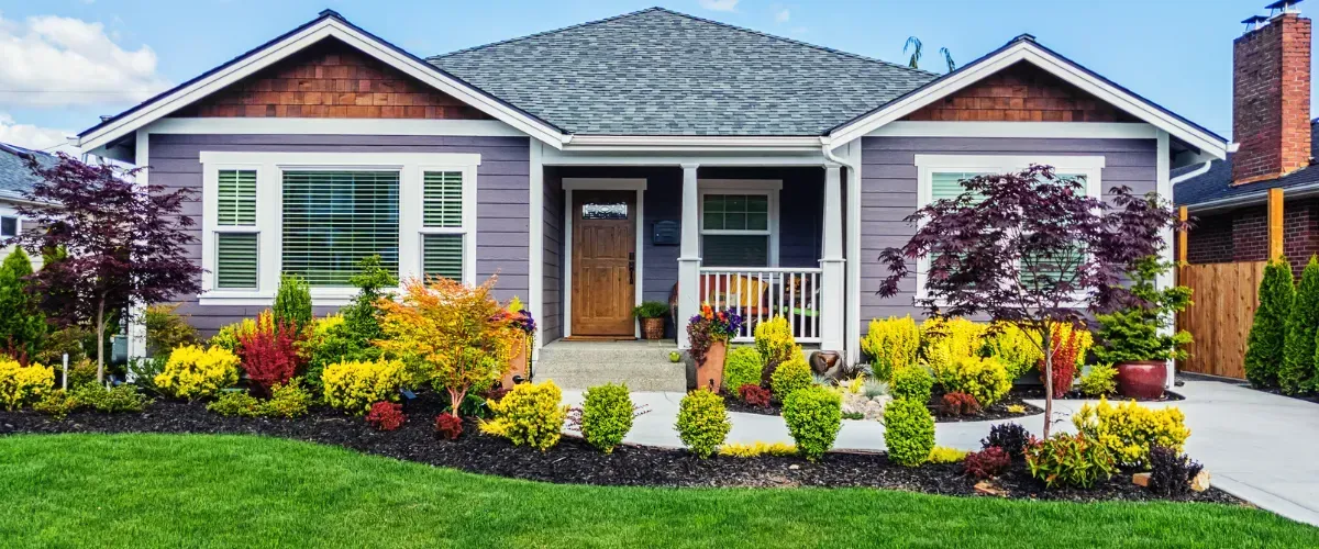  Bright and colorful front yard landscaping that enhances curb appeal of a suburban home.