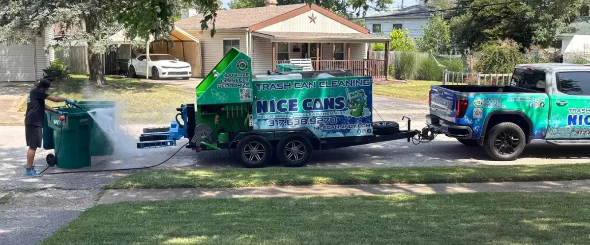 Nice Cans cleaning truck and technician washing bins in a suburban neighborhood.