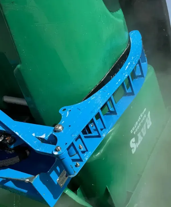 Close-up of a trash bin being cleaned with high-pressure water and specialized equipment.