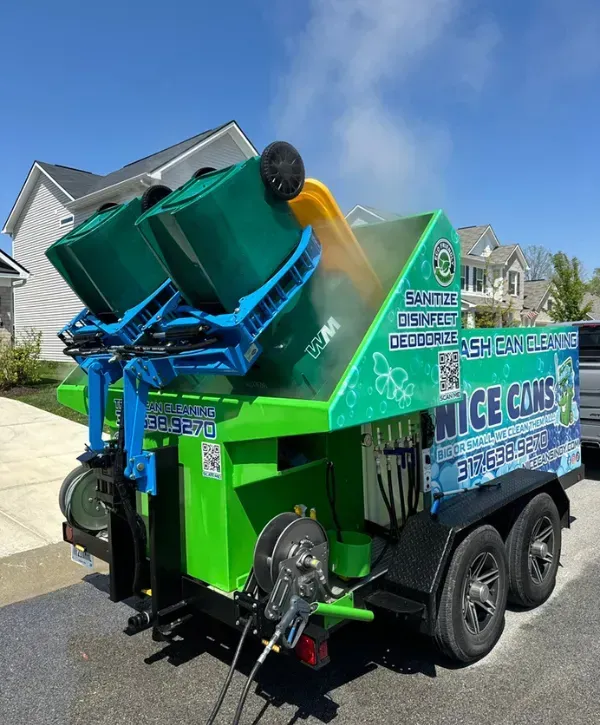 Curbside trash bin cleaning truck in action, sanitizing and deodorizing garbage cans in a residential neighborhood