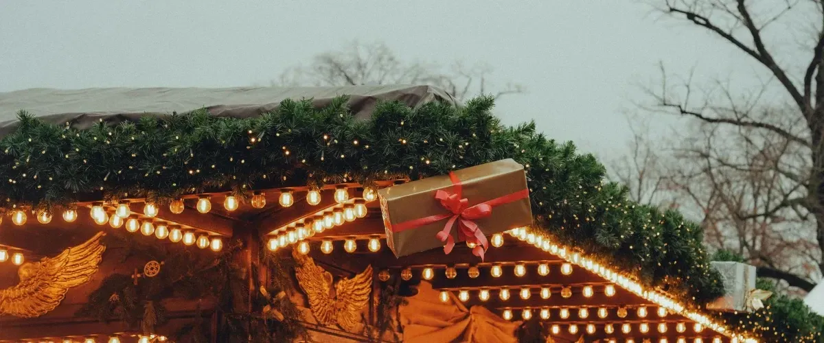  Two-story suburban home illuminated with permanent holiday lighting during nighttime