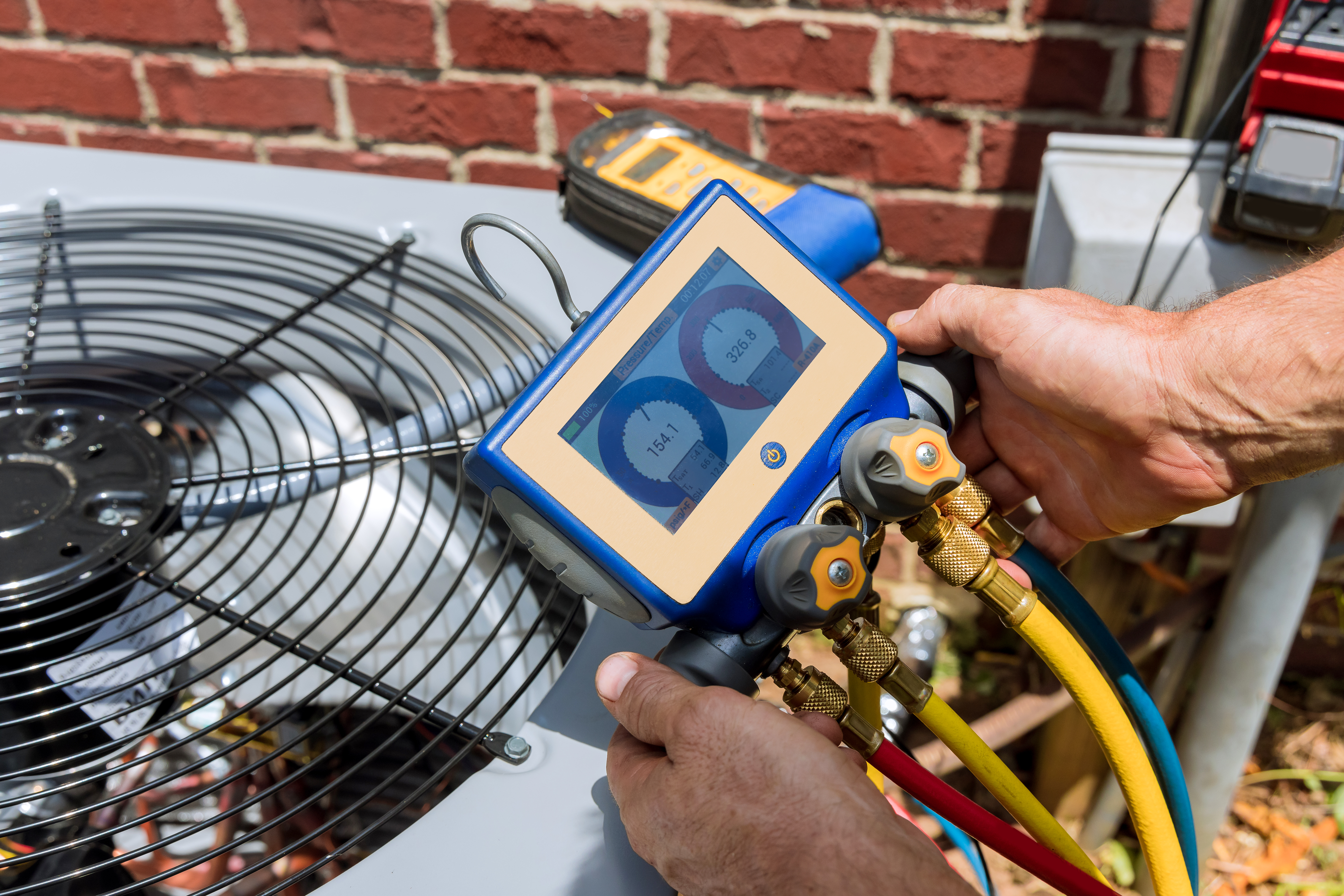 Professional checking air conditioner pressure gauges for Woodburn HVAC