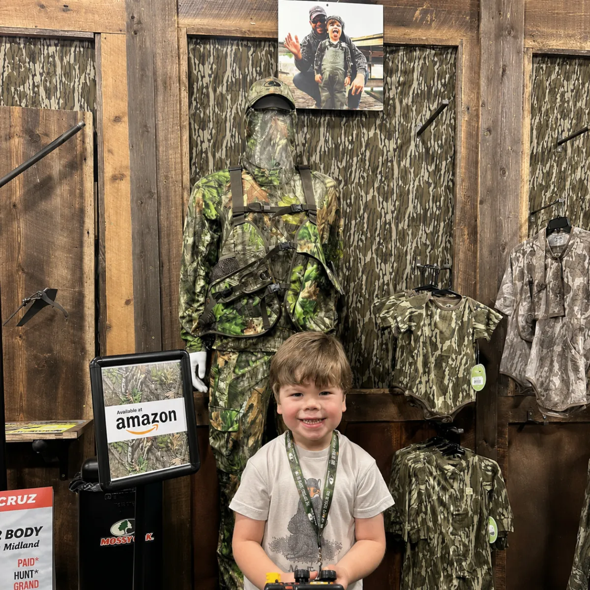 Father and child wearing outdoor adventure gear and camo clothing from top clothing brands amazon walking together near a pond