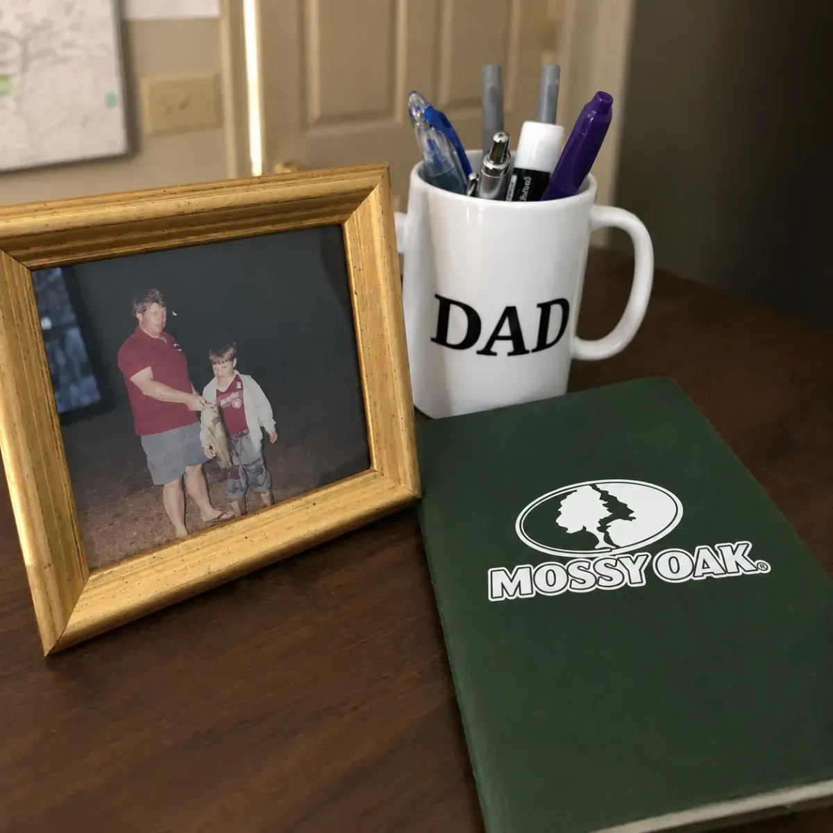 Framed family photo with Dad mug on desk representig the personal story behind Six Star Brands ecommerce growth agency