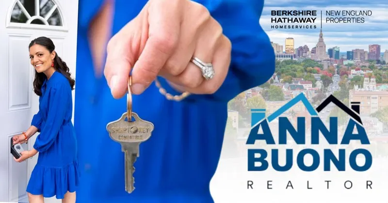 Anna Buono Realtor holding a house key near a front door