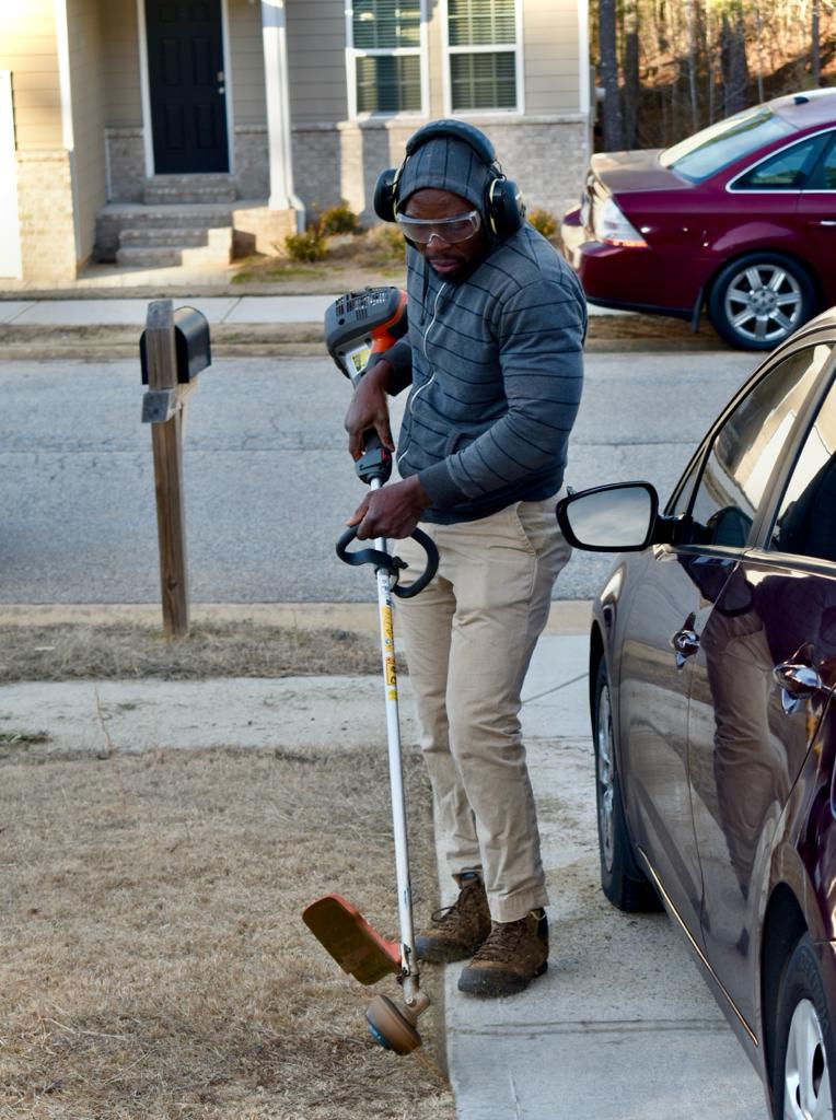a man is mowing the grass in the yard