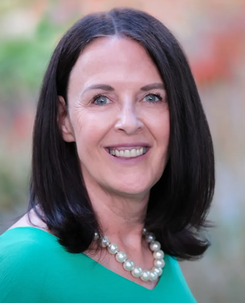 man in blue long sleeve shirt holding smartphone