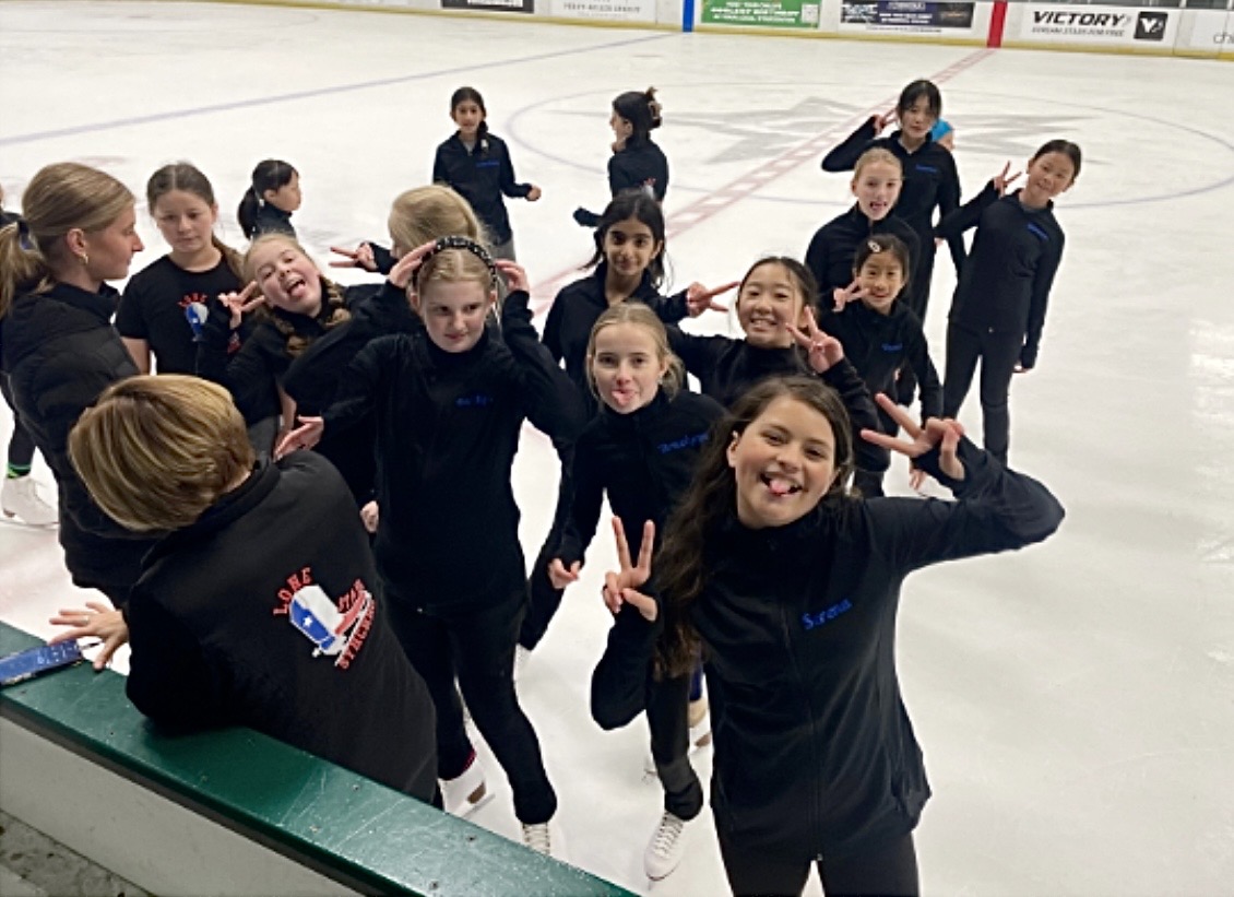 Young skaters smiling together on the ice