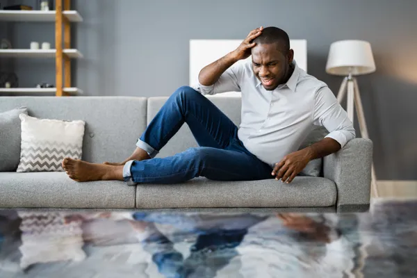 stressed homeowner finds his wooden floors flooded and wonders how to clean 