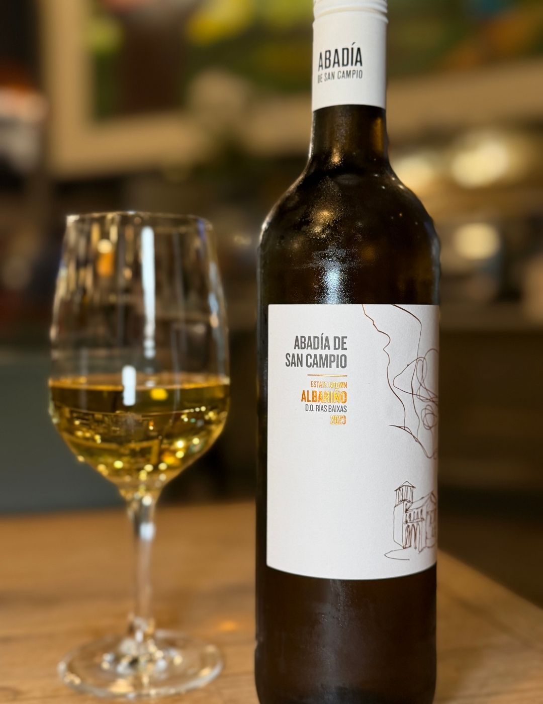 A glass of white wine on a wooden table