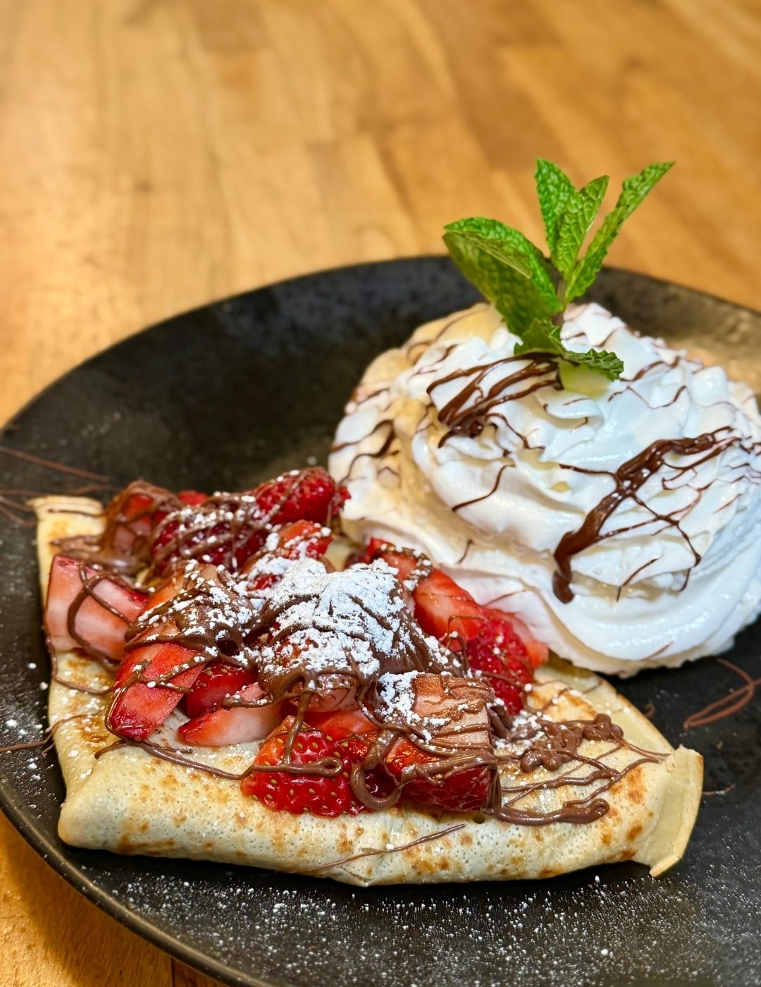 Crepe with strawberry and whipped cream