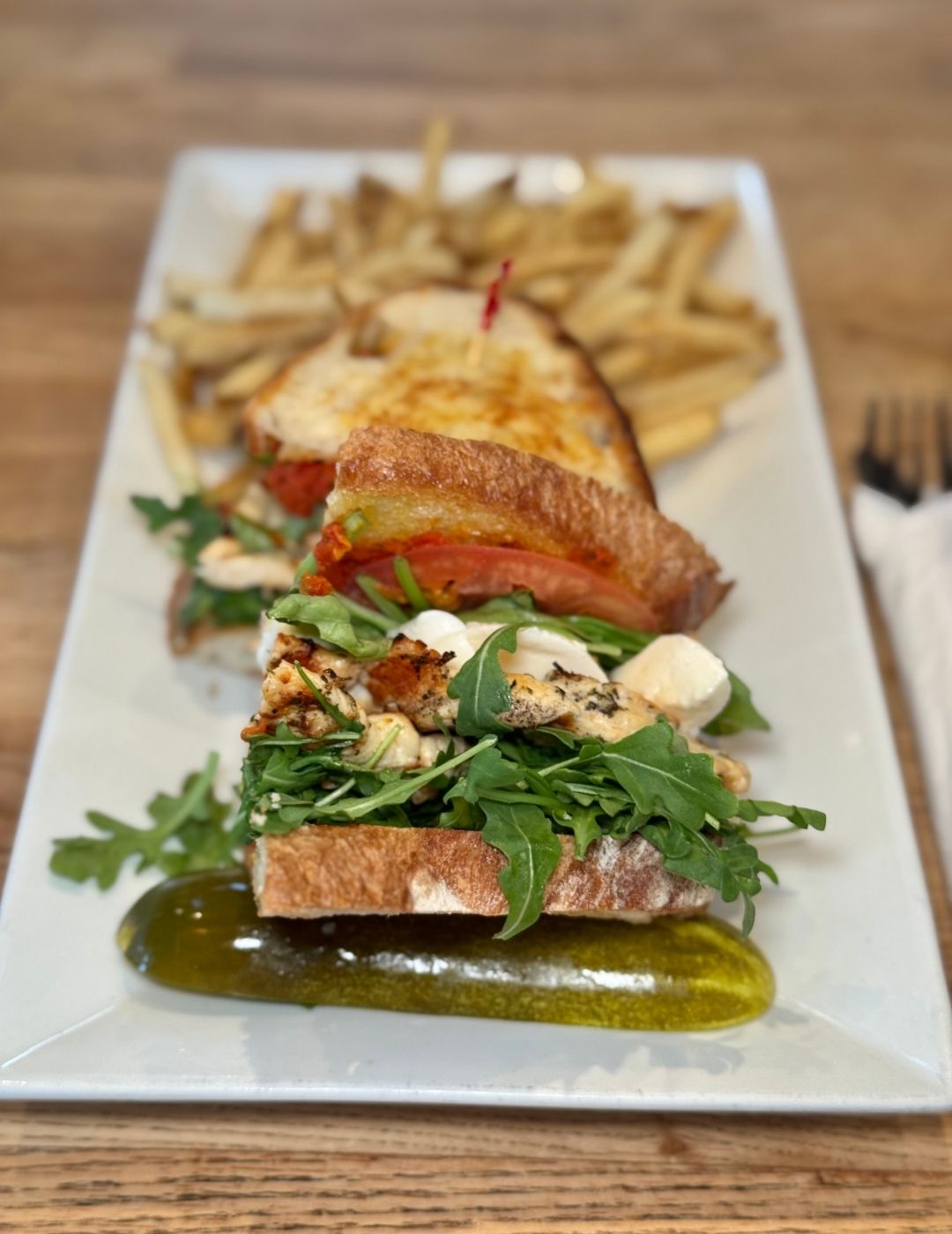 A flat lay of an charcuterie-style platter with vegetables and greens