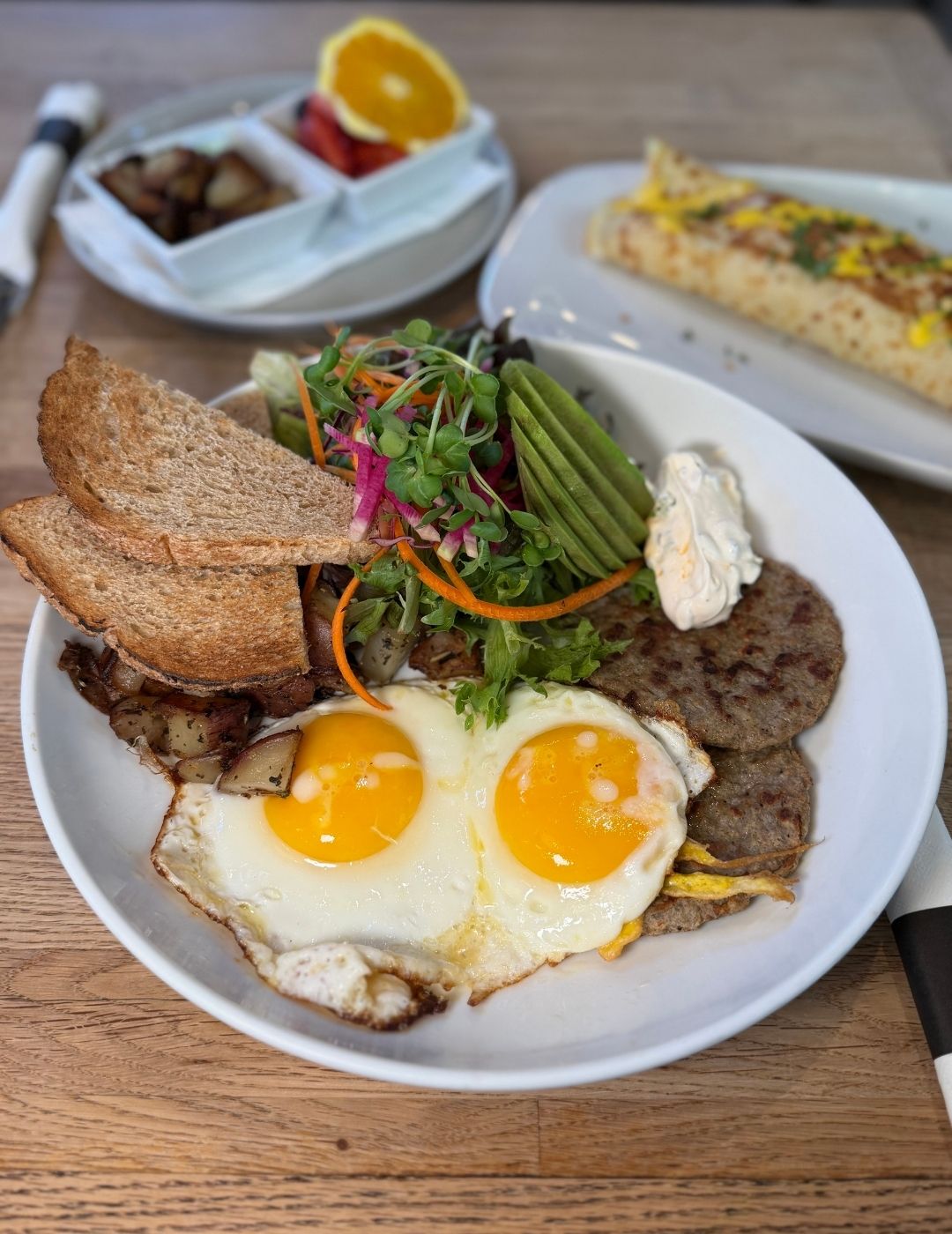 Breakfast Meal with eggs, protein, bread, and greens