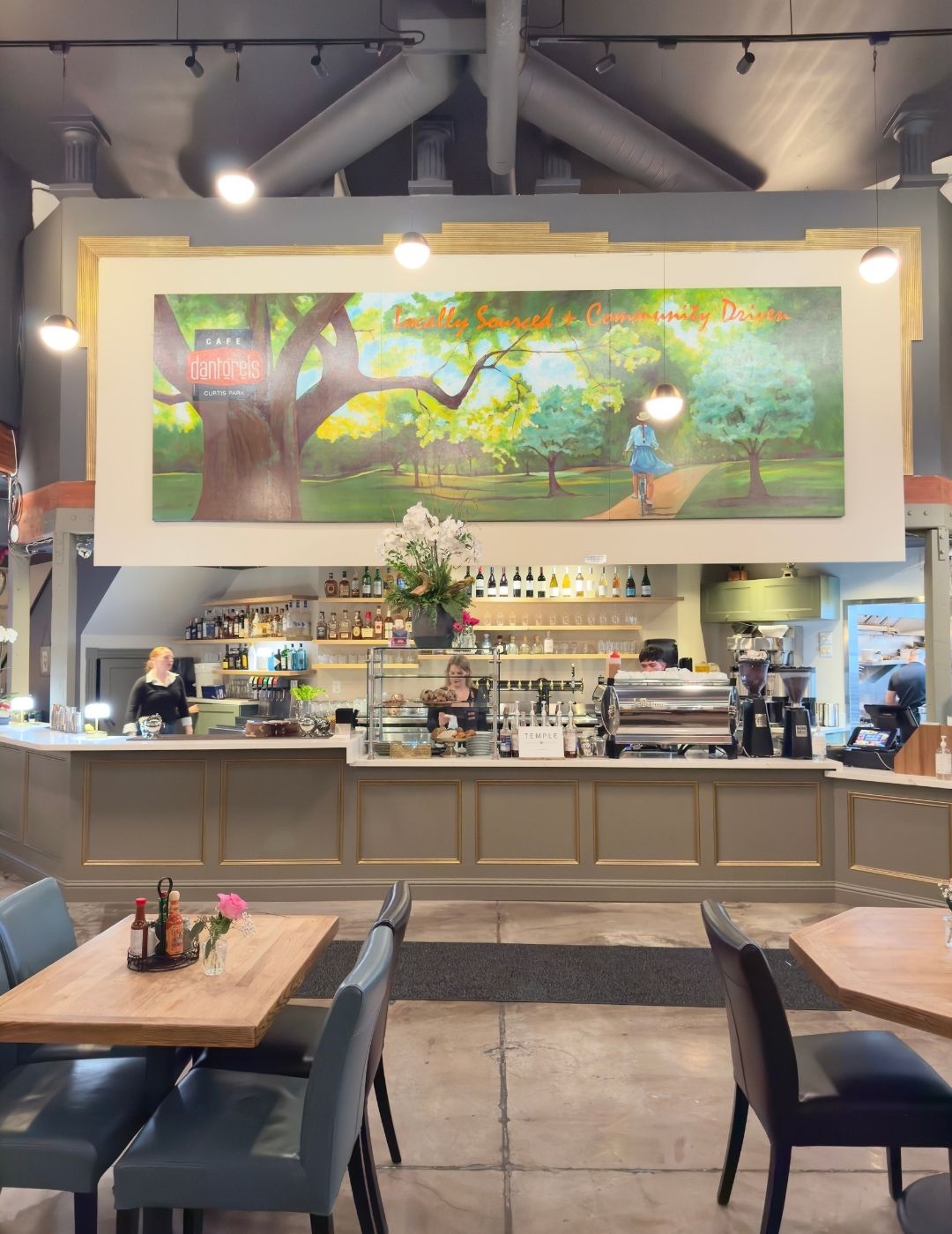 A warm, cozy restaurant interior with wood accents and natural light