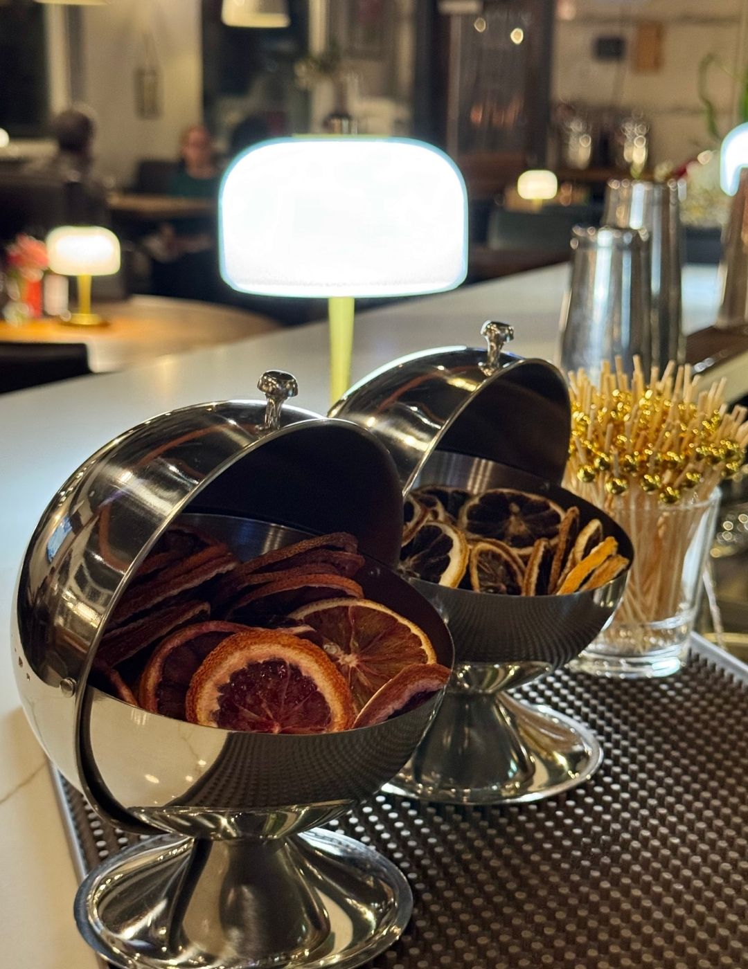 A cozy restaurant bar area with pendant lighting and warm wood tones