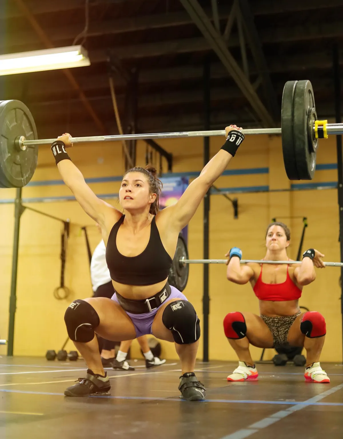 A member catches a snatch during Olympic weightlifting at CrossFit Fortius in Point Loma, San Diego