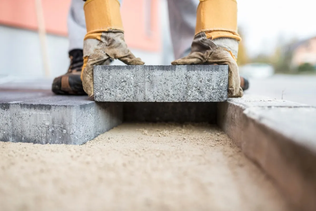 Installer adding a paver to a driveway in Coral Springs, FL 