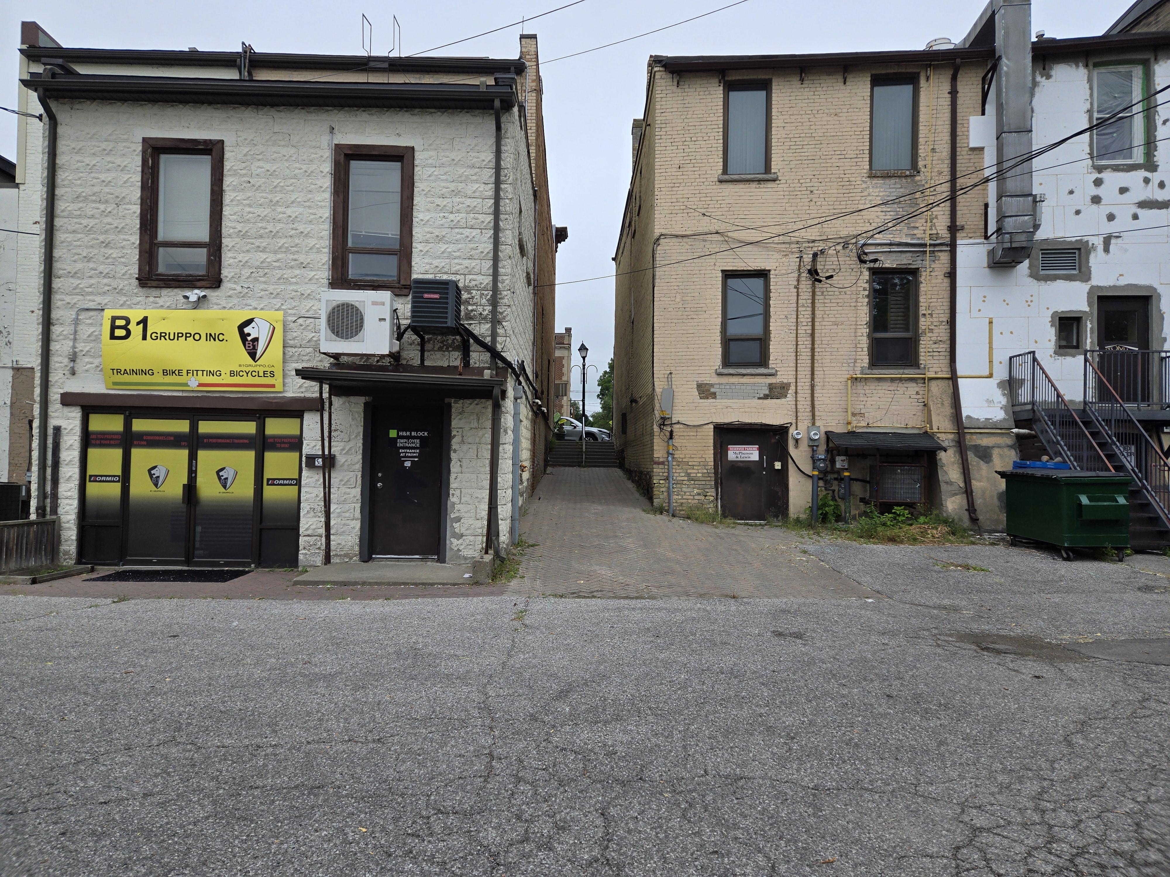 The alleyway connecting the parking lot behind Club X Indoor Golf to the Yonge Street west side sidewalk.