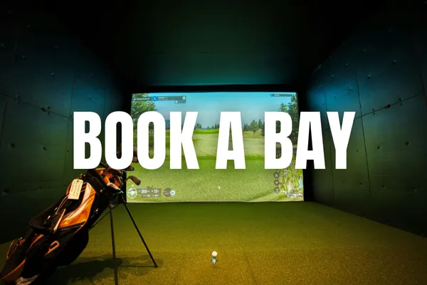 Indoor golf bay with 'book a bay' text 