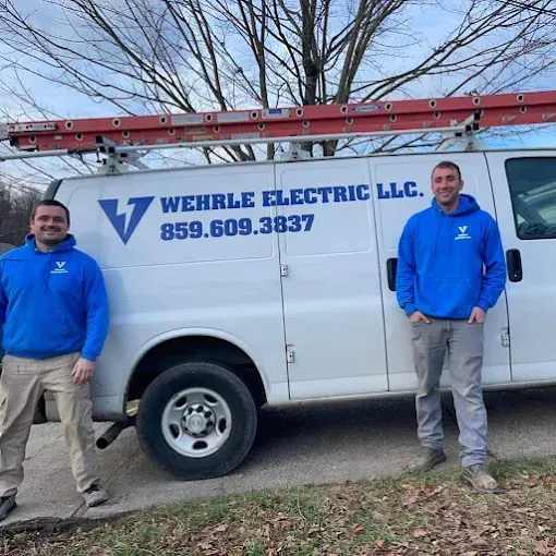 Licensed electricians from Wehrle Electric LLC standing beside their service van with company logo and phone number 859-609-3837, providing residential and commercial electrical services in Northern Kentucky and Cincinnati.