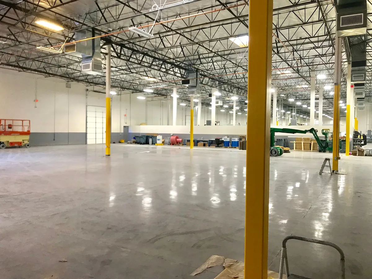 Medical manufacturing facility painting by DL Coatings: full plastic containment barriers, commercial wall coatings, and structural column safety paint.