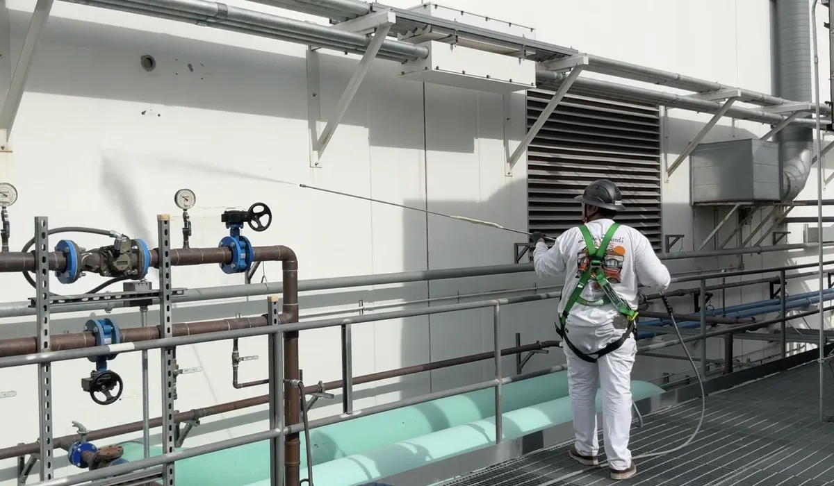 DL Coatings executes cooling tower power washing at Iron Mountain: catwalk fall-arrest harness safety, concrete decontamination, and prep washing.