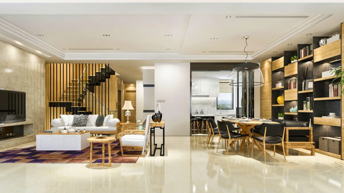 A luxurious and spacious apartment interior featuring a seamless integration of living and dining areas. The living space is defined by plush white sofas, an elegant glass coffee table, and a striking patterned rug, while the dining area boasts a stylish wooden table with chic black chairs. The room is divided by a modern vertical slat staircase leading to the upper level, enhancing the open-plan concept. Natural light floods the space, reflecting off the polished marble floors, and is complemented by sophisticated ceiling and pendant lighting. The design is a blend of comfort and modern elegance, perfect for urban living.