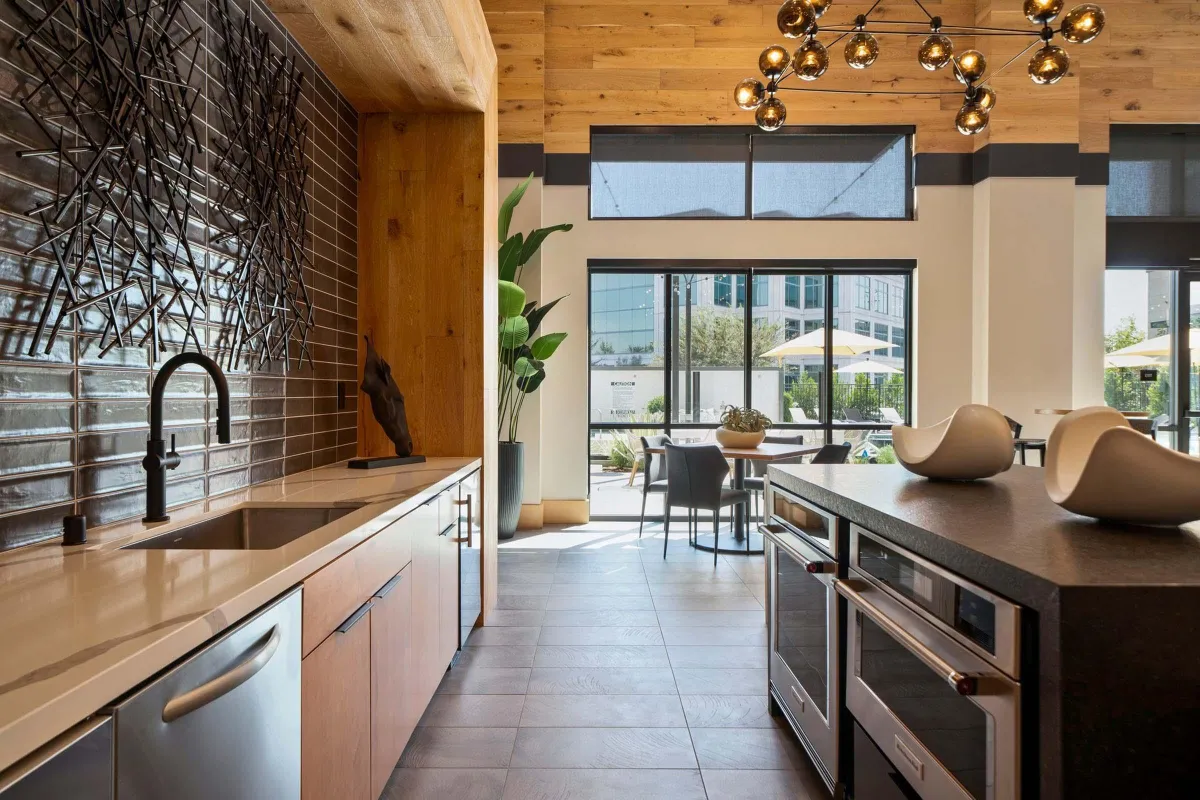 Kitchen design transformation concept showing transition from blueprint to fully remodeled kitchen with dark wood island and stainless steel appliances by Elci Cabinets and Floors.