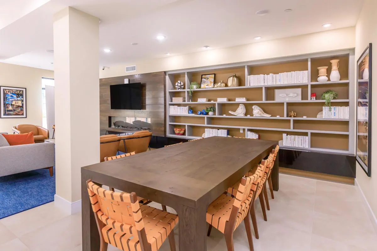 Modern custom-built entertainment center with open shelving, decorative accents, and integrated TV, designed by Elci Cabinets and Floors.