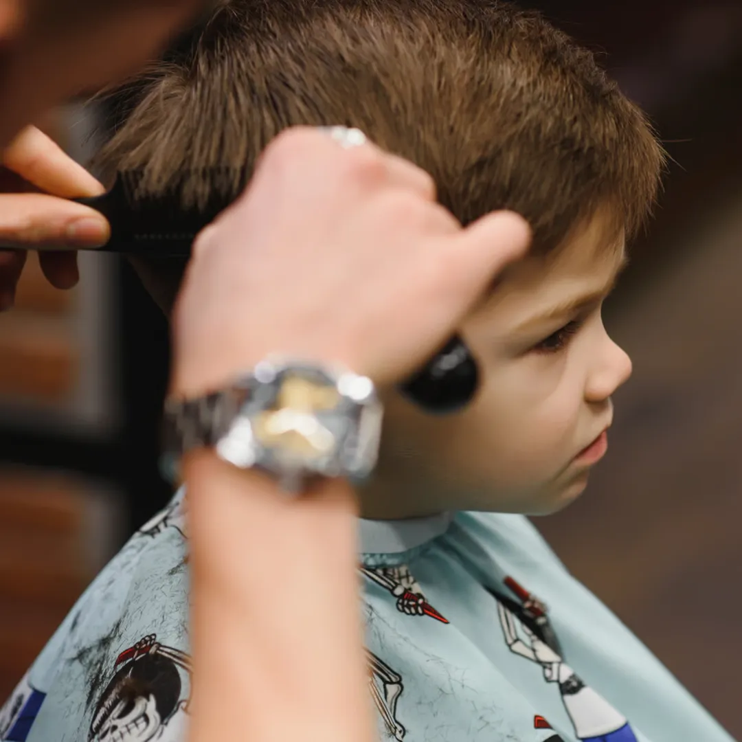 Man wearing a high skin fade with short thick hair on top