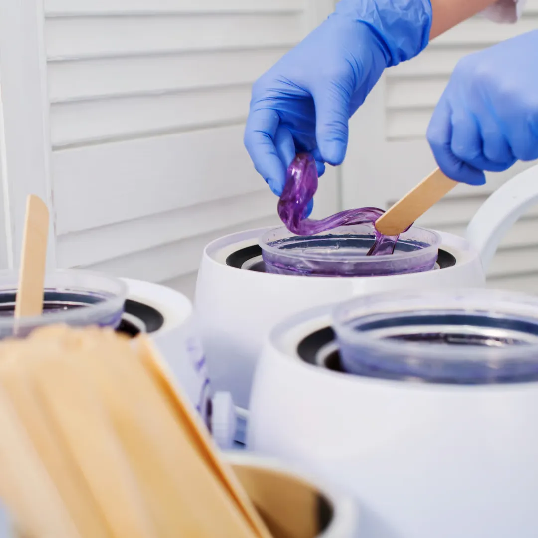 Esthetician preparing a client's skin before a professional waxing treatment