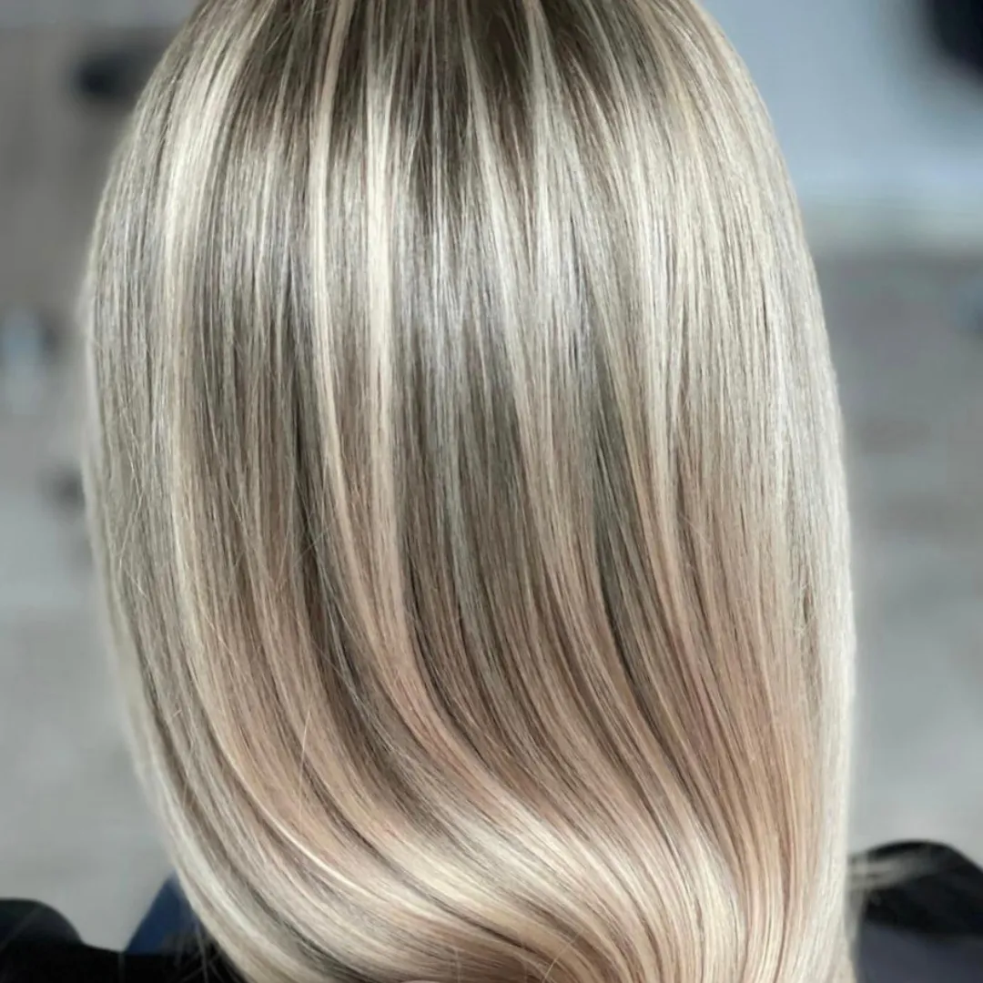 Silver hair with dark and bright lights leading to balayage look, blending hair together.