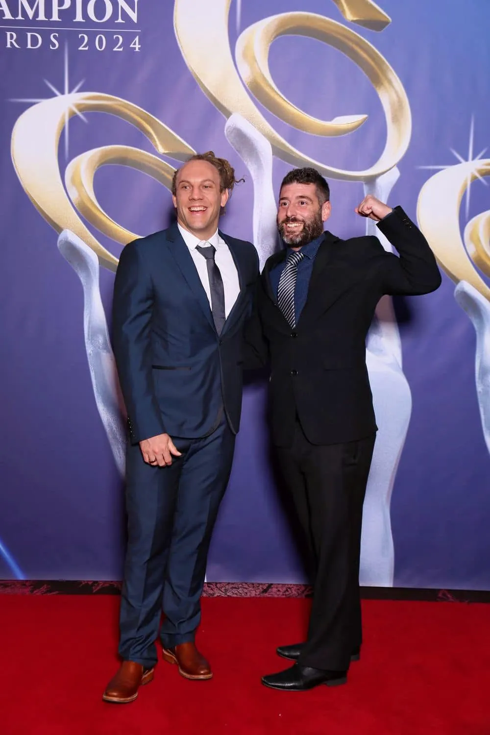 two man in a suit smiling