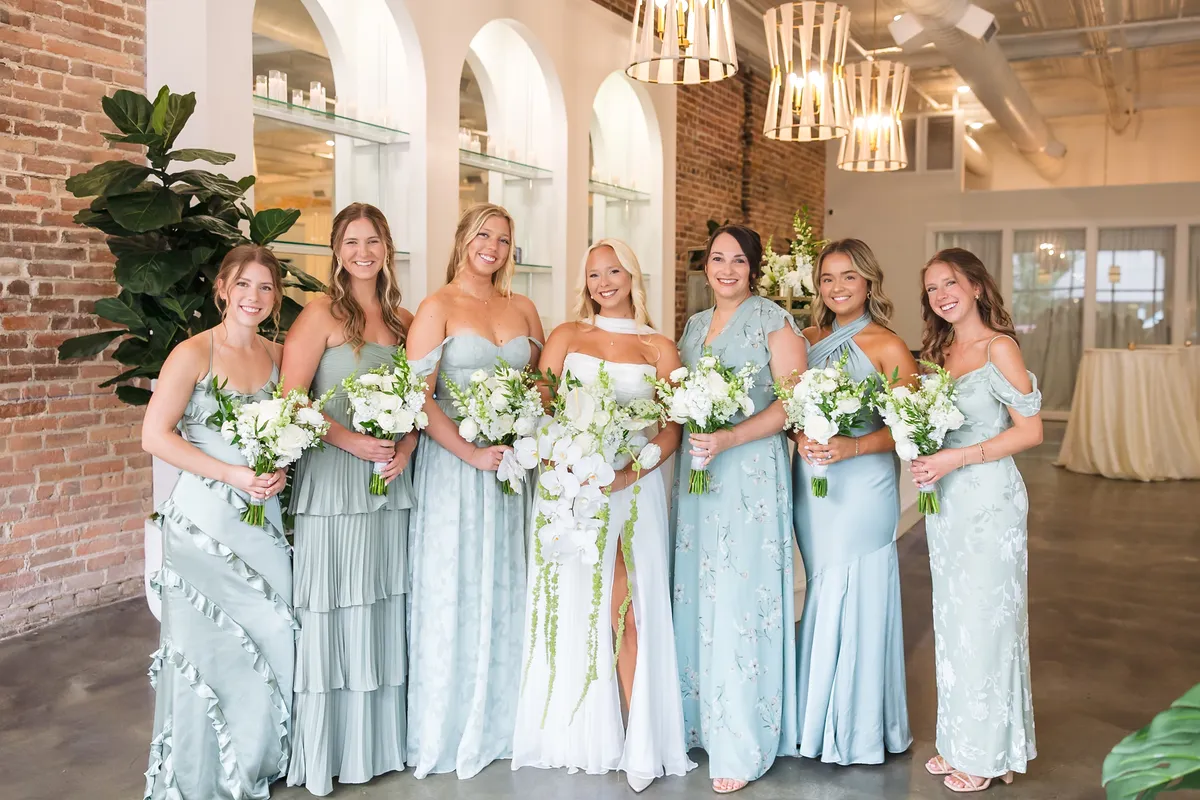 bride-and-bridesmaids-smiling-inside-beautiful-venue