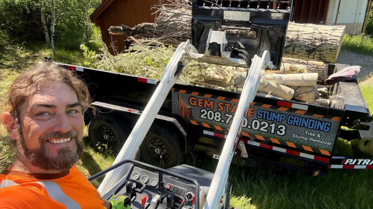 Professional tree removal specialist with heavy equipment and trailer ready for tree removal services in Sun Valley Idaho