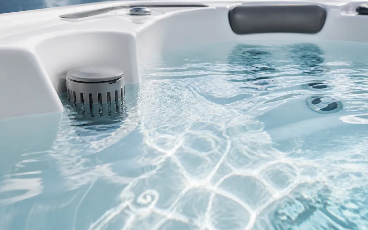 Close up shot of crystal clear, calm water inside a hot tub.