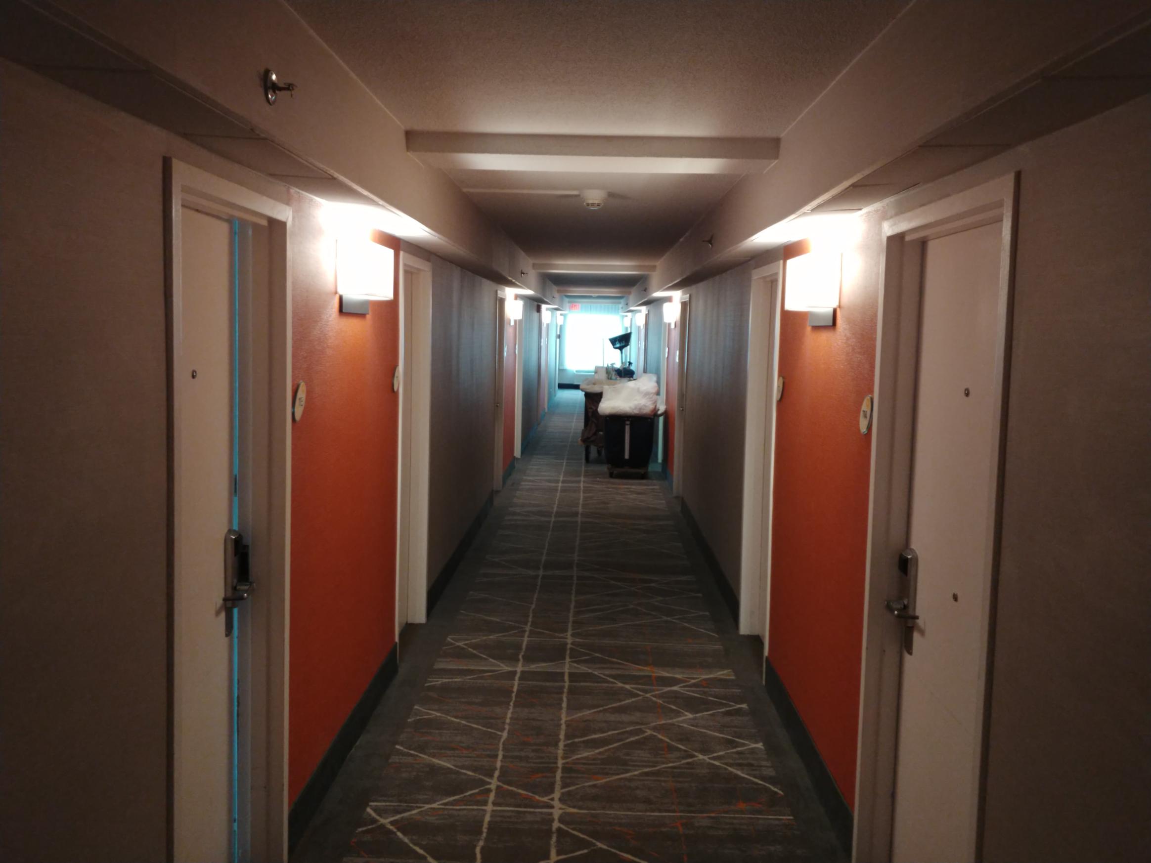 hotel hallway lighting installation with wall sconces Westchester NY