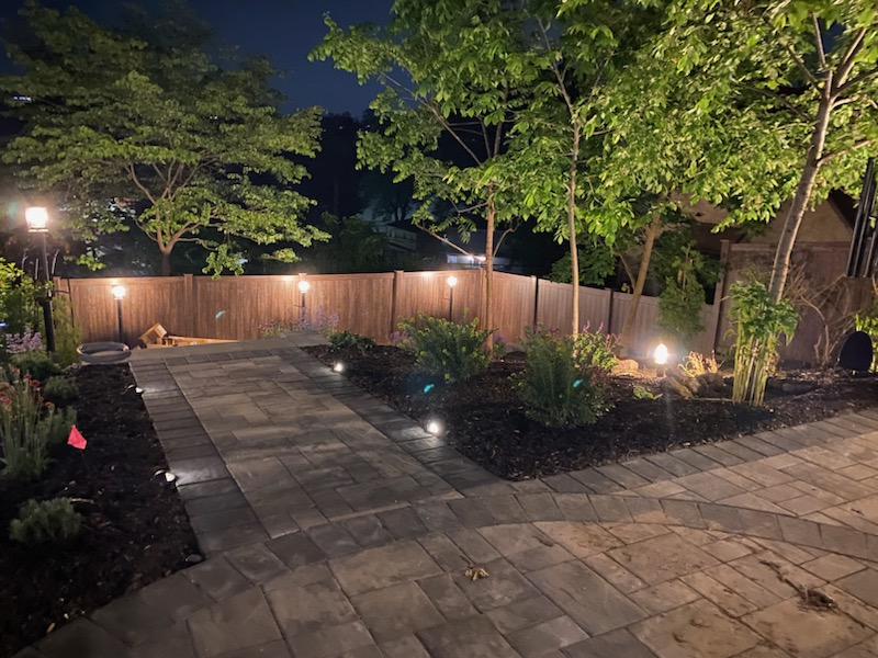 outdoor landscape lighting design with pathway lights and trees Westchester NY