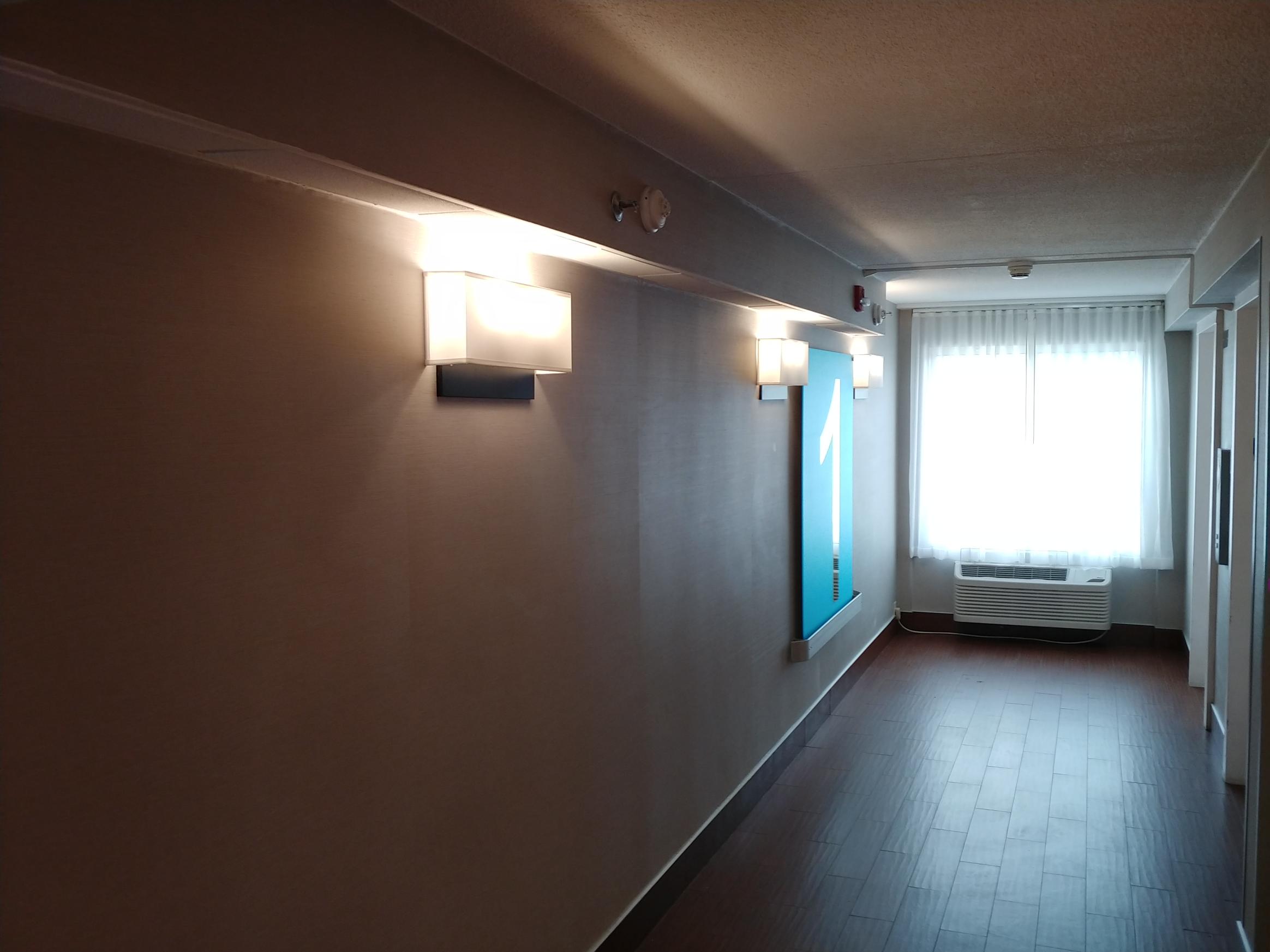 hallway wall sconce lighting installation in residential building Westchester NY