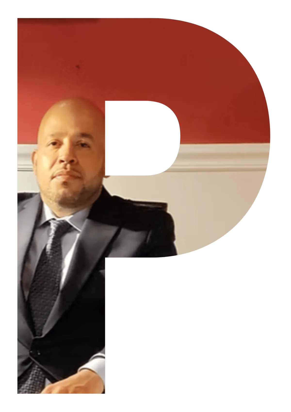 Eufemio Perez seated in a chair wearing a dark suit and tie, facing forward against a red and white wall background.