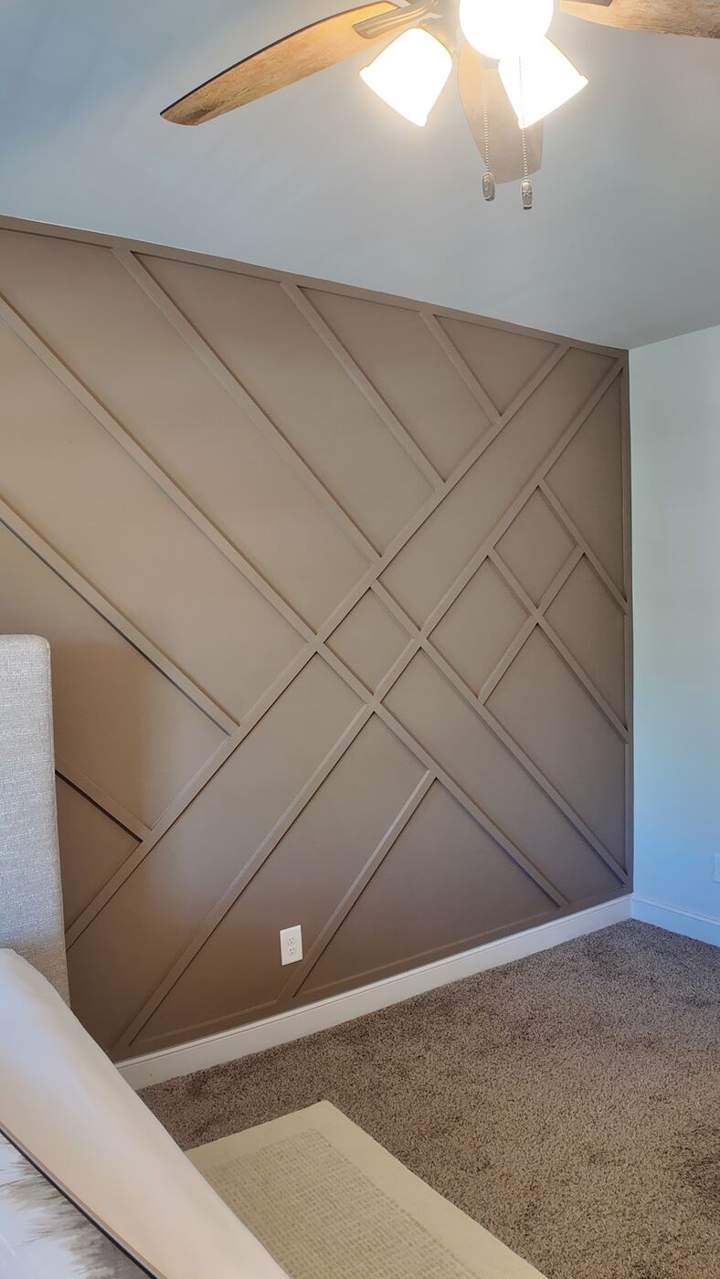 Custom geometric accent wall in a bedroom